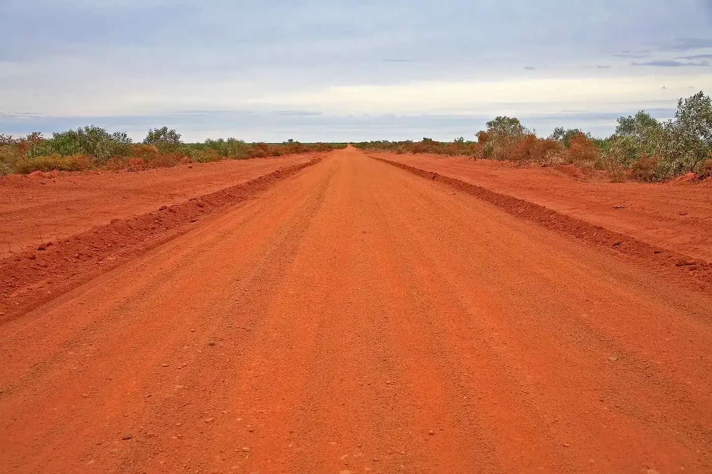 A corrugated red dirt road through the Australian outback