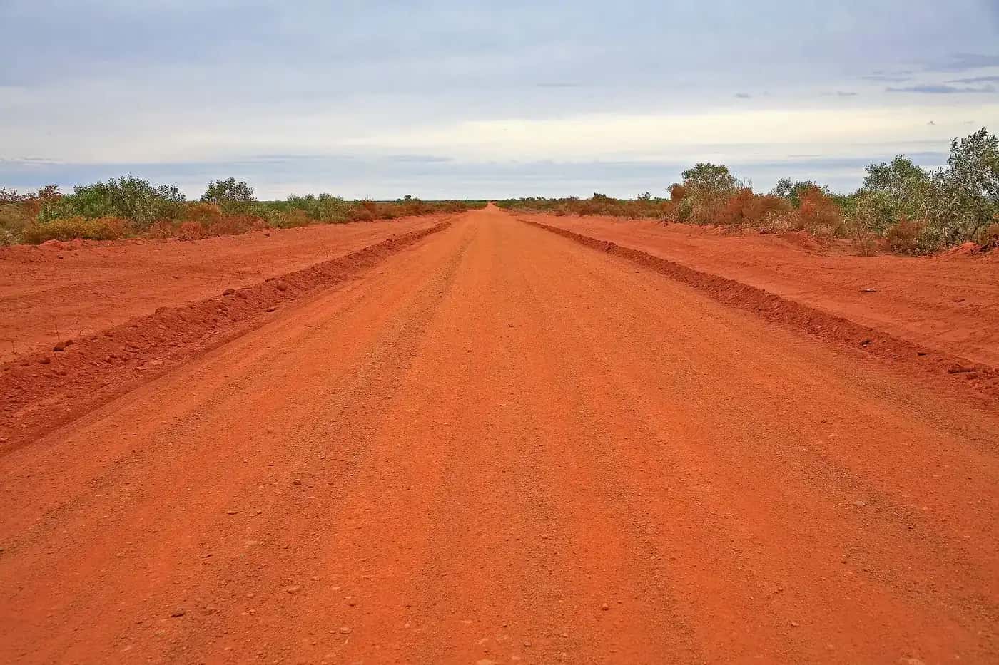 A corrugated red dirt road through the Australian outback